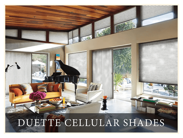 A living room with couches and tables, piano in the center of the room.