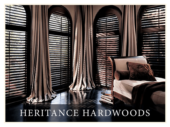 A living room with arched windows and wooden blinds.
