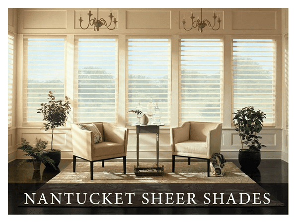 A living room with three windows and two chairs.