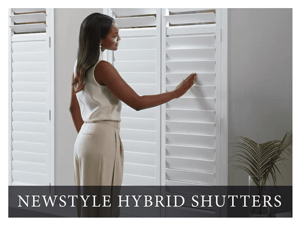 A woman in white shirt and skirt holding onto shutters.