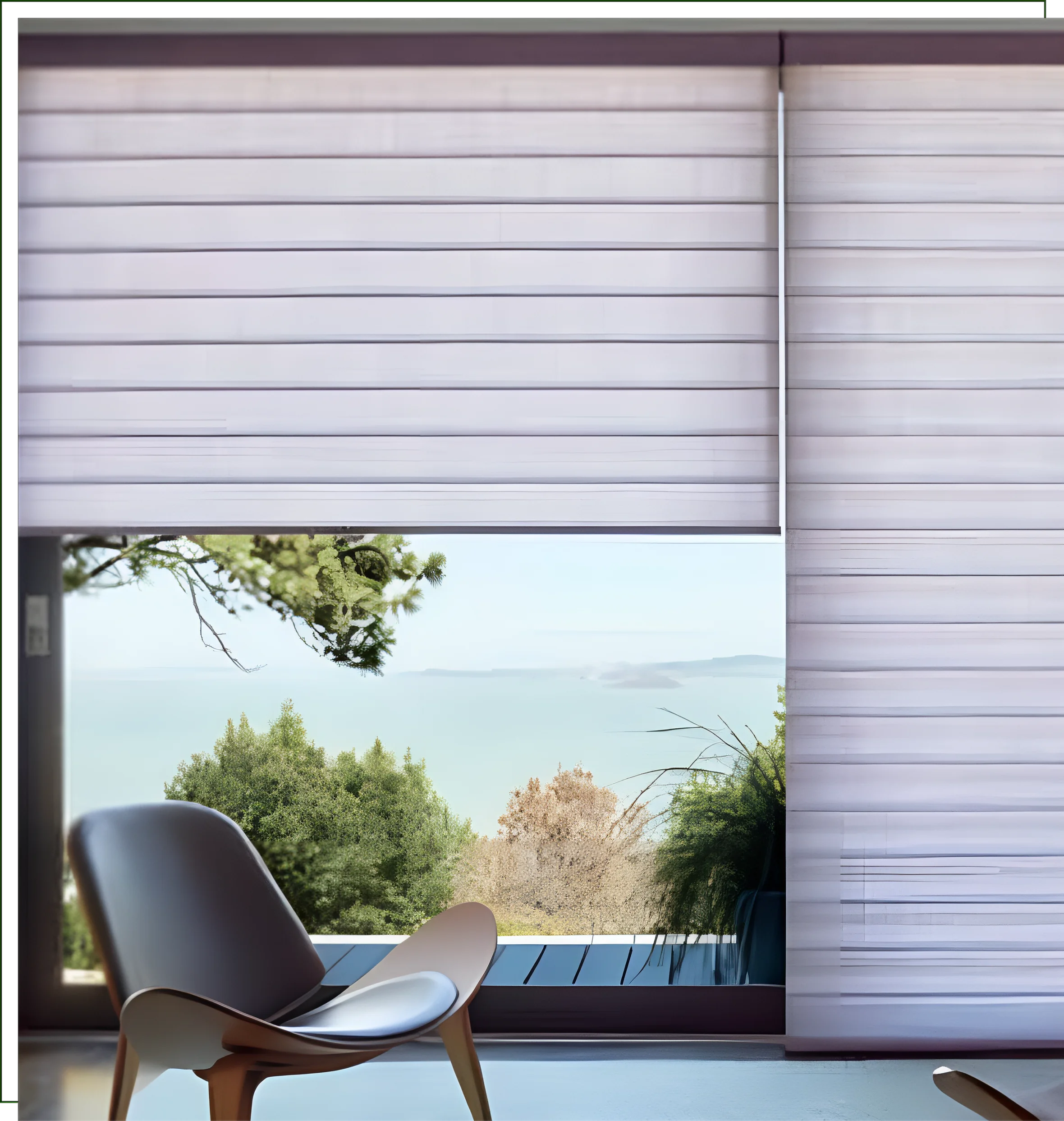 A chair and window with a view of the ocean.