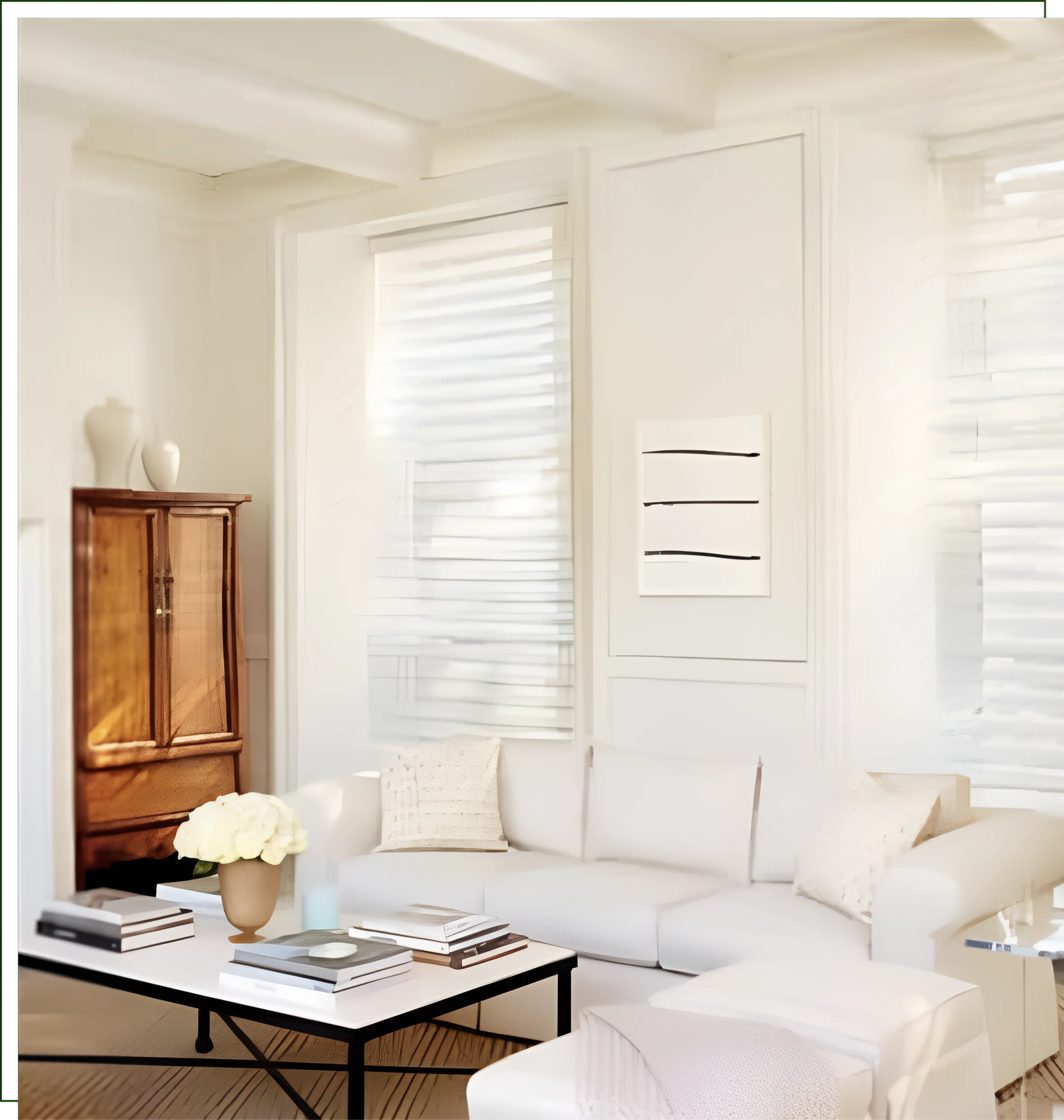 A living room with white furniture and windows.