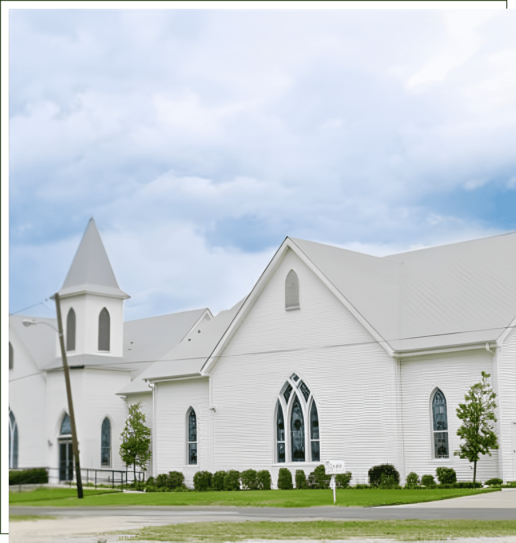 A white church with steeple and large windows.