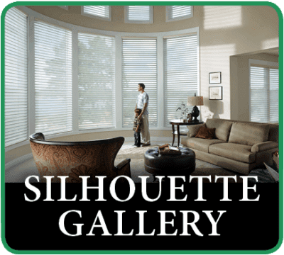 A man standing in front of a window with blinds closed.