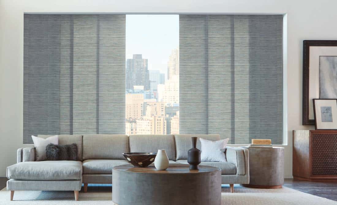 choosing-the-best-window-treatment A living room with grey furniture and large windows.