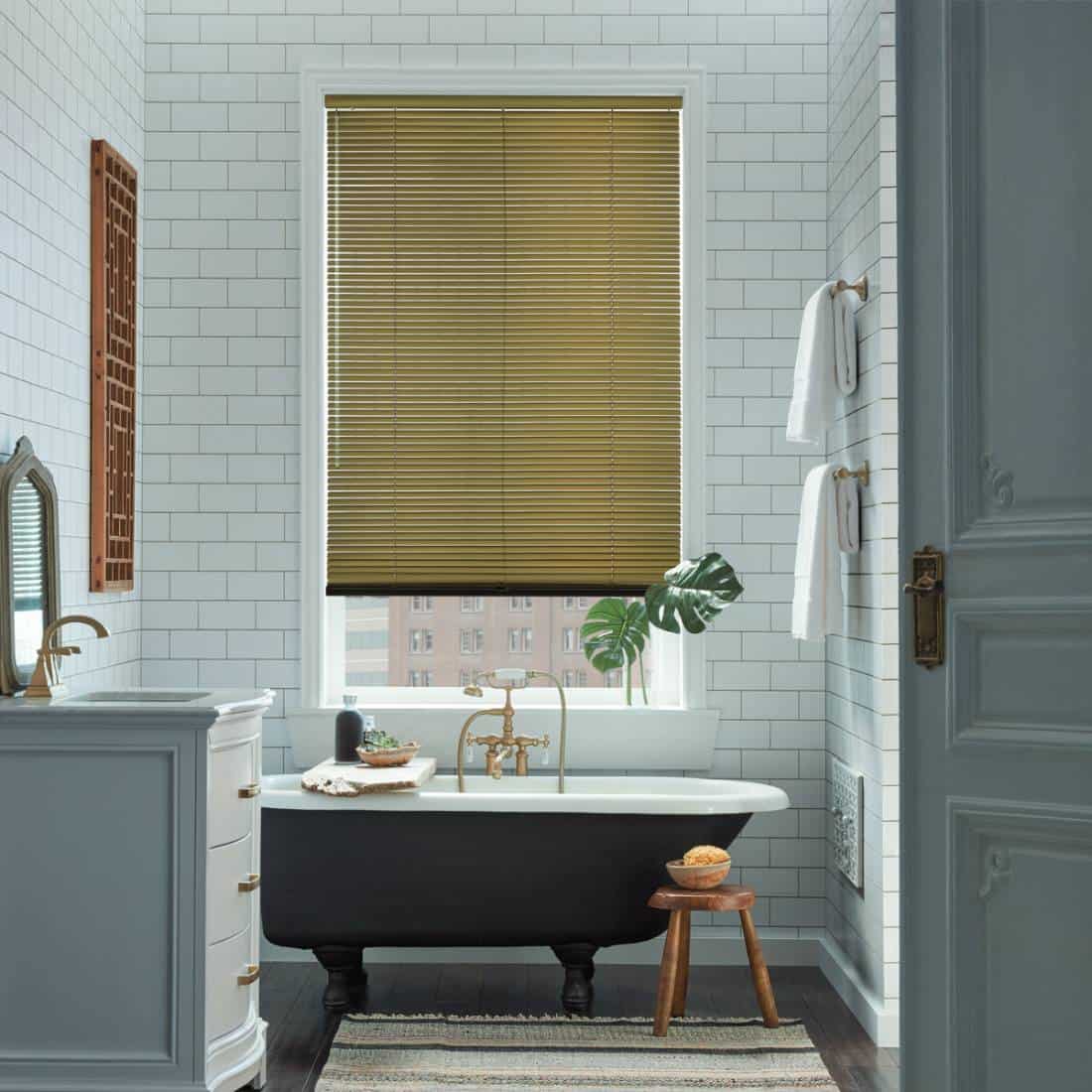 choosing-the-right-hunter-douglas-window-blinds-for-your-home A bathroom with a tub, sink and toilet.