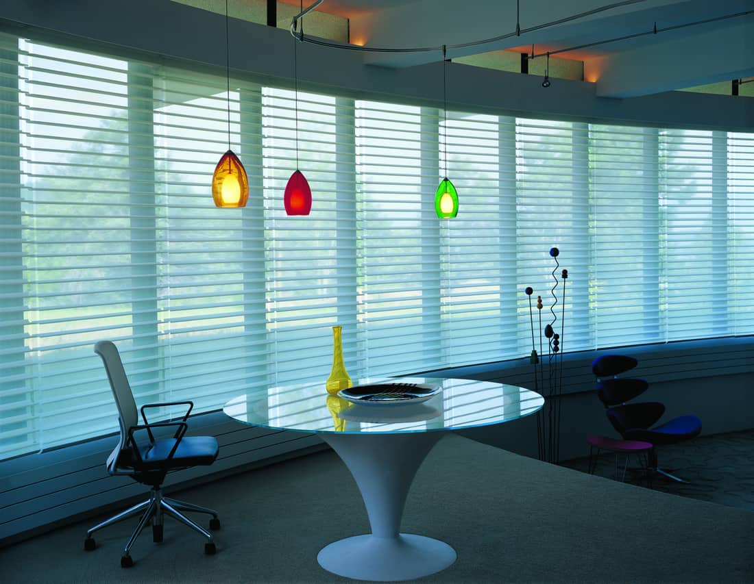 A room with several windows and a table