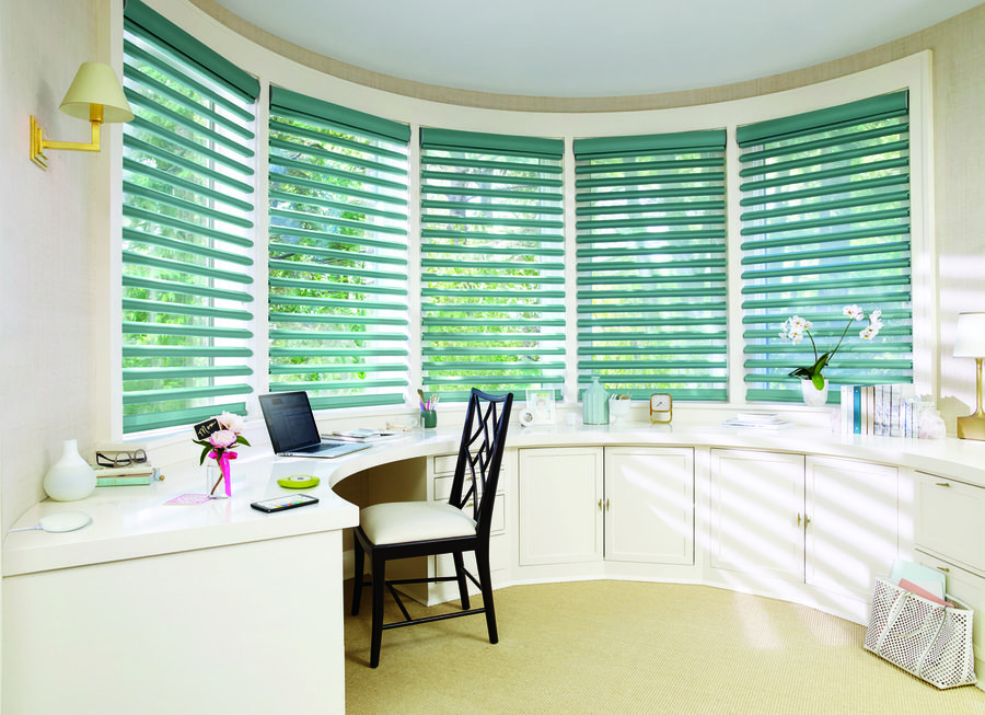 A room with many windows and chairs in it