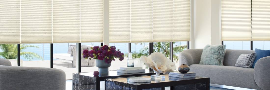 premium-hunter-douglas-window-shades-for-homes A table with flowers and a vase on it
