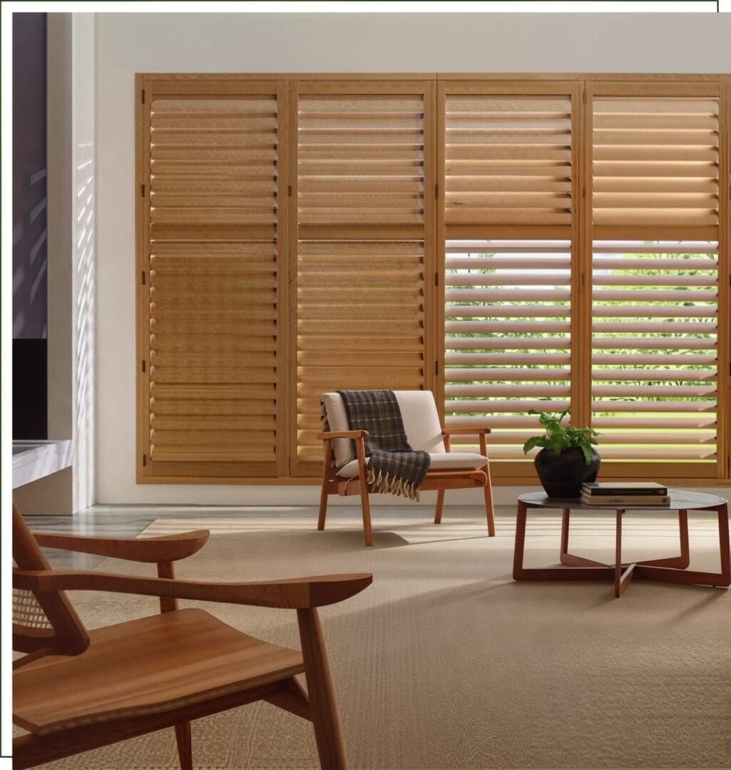 A living room with wooden furniture and large windows.