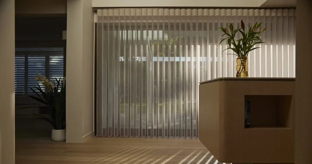 Modern room with sheer vertical curtains and plants