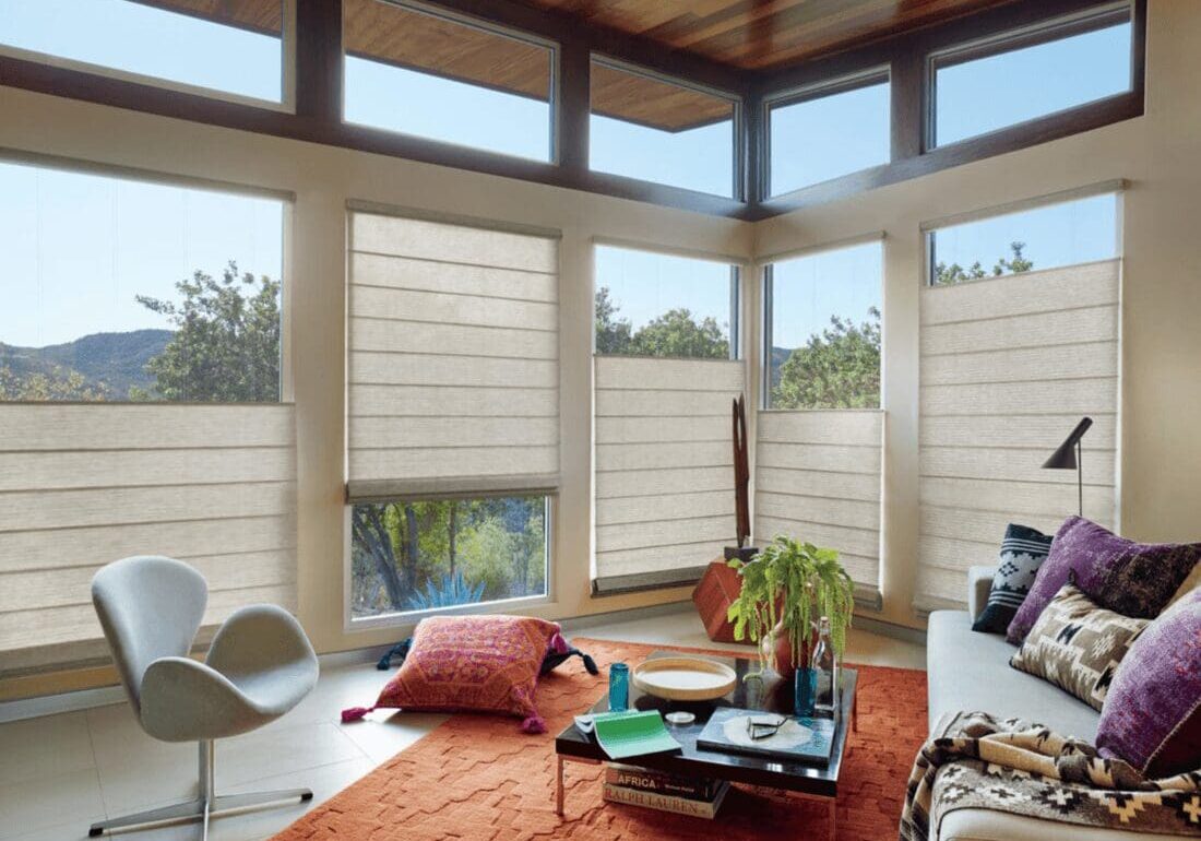 A living room with many windows and furniture
